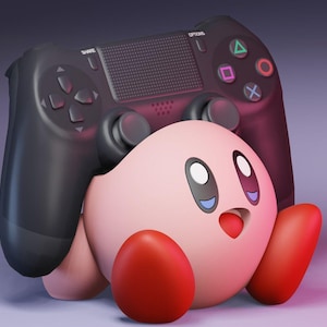 May include: A pink and red cartoon character with a black PlayStation controller on its head. The controller is facing forward and the character is looking up.