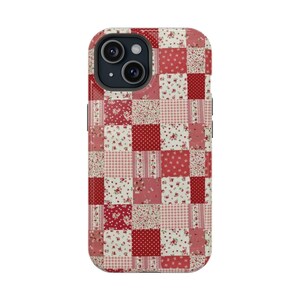 May include: A phone case with a patchwork design in shades of red and pink. The case features a variety of patterns, including floral prints, polka dots, and gingham checks. The case is designed to fit a smartphone with a dual-lens camera.