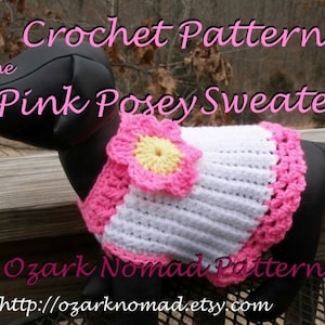 May include: Crochet pattern for a pink and white dog sweater with a pink flower. The pattern is called "Pink Posey Sweater" and is available from Ozark Nomad Patterns at http://ozarknomad.etsy.com.