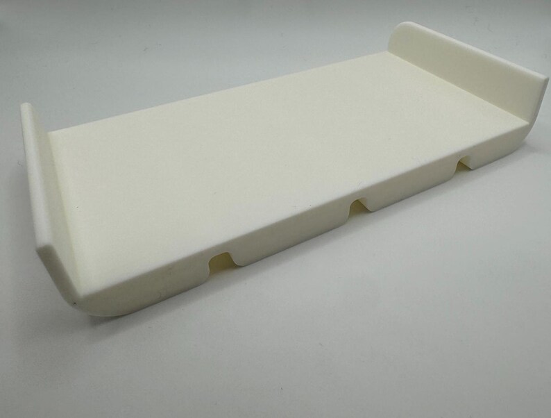 May include: White plastic tray with three indented sections. The tray is rectangular and has rounded edges.