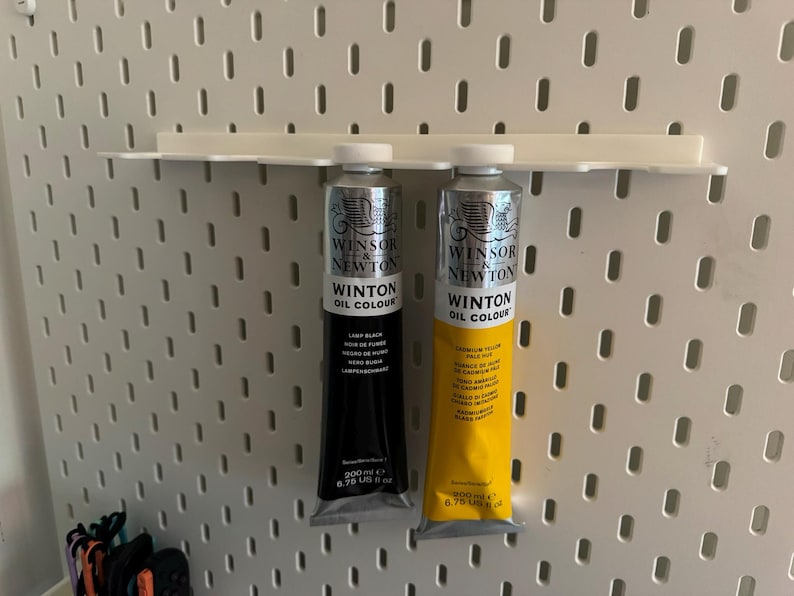 May include: Two tubes of Winsor & Newton Winton Oil Colour paint. One tube is black, labeled "Lamp Black", and the other is yellow, labeled "Cadmium Yellow Pale Hue". Each tube contains 200 ml or 6.76 US fl oz of paint.