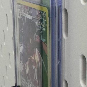 May include: A clear plastic graded card case with a black card holder. The card case has a label that reads "CGC UNIVERSAL GRADE" and a number "9". The card inside the case is a Pokemon card featuring the character "Malamar" from the "Silver Tempest" set. The card is a "Character Rare" card.