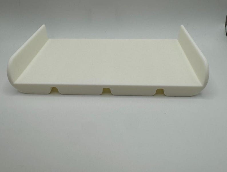 May include: White plastic tray with rounded edges and three small holes in the bottom.