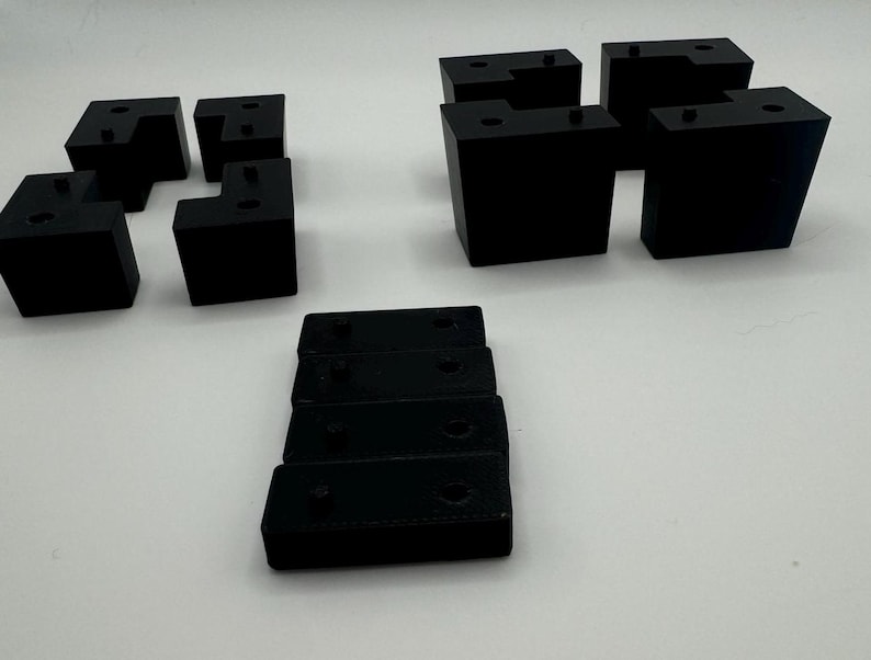 May include: A set of black plastic corner brackets, some are L-shaped and some are straight. There are also five smaller black plastic pieces.