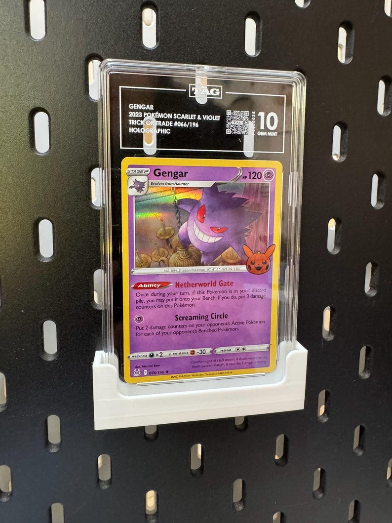 May include: A graded Gengar Pok&eacute;mon card from the 2023 Scarlet & Violet Trick or Trade set, holographic, graded 10 Gem Mint. The card features a purple Gengar character with the text "Gengar" and "120". The card is in a protective case.