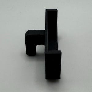 May include: Black plastic corner bracket with a small lip on one side.