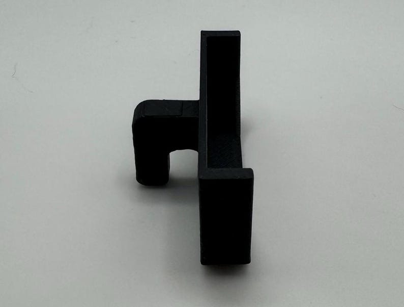May include: Black plastic corner bracket with a small lip on one side.