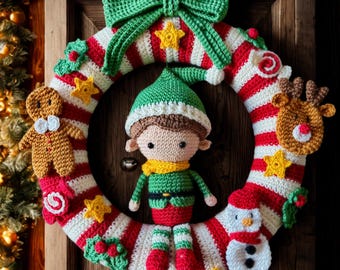 May include: A handmade Christmas wreath with a red, white, and green color scheme. The wreath features a crocheted elf, gingerbread man, reindeer, and snowman. It is decorated with a green bow, stars, and holly.