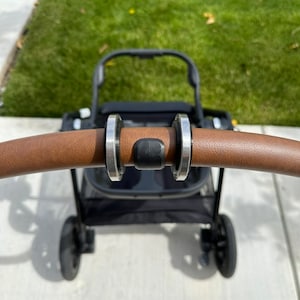 StrollerRoller: Easily roll your Nuna Triv Next stroller in and out of your trunk and protect the handle too! For Nuna Triv Next only