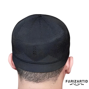 May include: A black knitted skullcap with a textured surface.