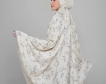 Könnte beinhalten: Cremefarbenes Gebetskleid-Set mit floralem Muster. Das Set beinhaltet eine Kopfbedeckung und eine lange, fließende Robe. Das florale Design ist in einem gedämpften Grauton gehalten. Das Kleidungsstück ist aus leichtem Stoff gefertigt.