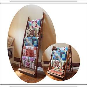 May include: A wooden quilt rack displaying several colorful, patterned quilts. The rack has a ladder-like design with horizontal bars to hold the quilts. The quilts feature various geometric and floral designs in shades of blue, red, green, and purple.