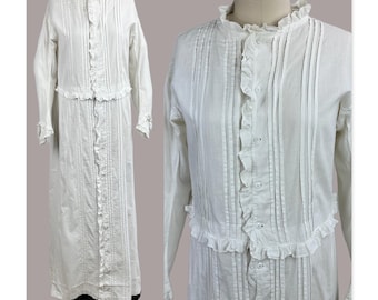 May include: A white dress and jacket set. The dress has vertical pleats and a ruffled trim. The jacket is cropped and has ruffles. The garments are displayed on a mannequin and a dress form. The dress and jacket are made of a light fabric.