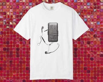 May include: White t-shirt featuring a grayscale illustration of a music player wrapped with a cord and connected to earbuds. The design is centered on the shirt, with the earbuds' cords extending downwards. The shirt has a crew neck and short sleeves.