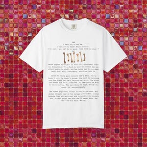 May include: White t-shirt with a script design, including the word "LEE" and bone illustrations. The script contains phrases such as "I want you to eat me" and "Bones and all!" The shirt has a crew neck and short sleeves.