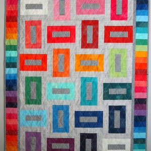 May include: A patchwork quilt with a variety of colours and patterns. The quilt is made up of squares and rectangles, each with a different colour and pattern. The quilt is a great example of the beauty of handmade crafts.