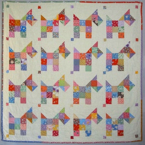 May include: A patchwork quilt with a design of 16 colorful dogs. Each dog is made of small squares of fabric in various colors and patterns.