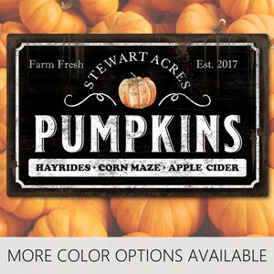 May include: A rectangular black sign with white text reading Farm Fresh Stewart Acres Est. 2017 PUMPKINS and Hayrides, Corn Maze, Apple Cider. The sign features a central illustration of a single orange pumpkin and a distressed, weathered finish.