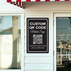 May include: A rectangular black metal sign with white text and a QR code. The text reads CUSTOM QR CODE Metal Sign and Customize your text and add your QR Code. The sign features rounded corners with small mounting holes at each corner.