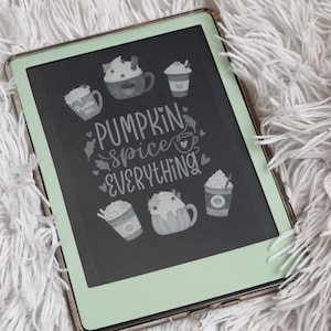 May include: A digital drawing of a green chalkboard with the text "Pumpkin Spice Everything" in white. The chalkboard is surrounded by a silver frame and has a green background. There are several drawings of mugs with whipped cream and pumpkin spice on the chalkboard.
