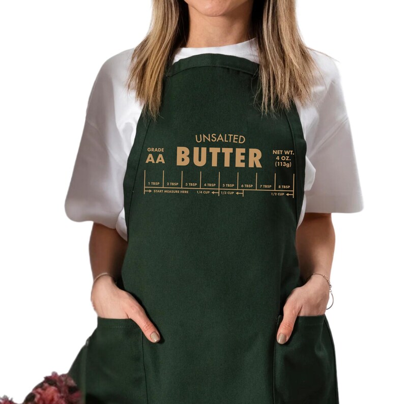 May include: Dark green apron with the words "UNSALTED BUTTER" in gold lettering. The apron has a measurement guide for butter, with measurements in tablespoons and cups. The net weight is 4 oz (113g).