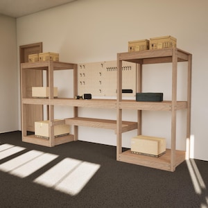 May include: A wooden workbench with multiple shelves and storage boxes. A pegboard with hooks and tools is mounted on the back. The workbench is in a well-lit room with a dark floor.