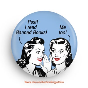 May include: A blue button featuring a vintage illustration of two women whispering. The text on the button reads "Psst! I read Banned Books! Me too!"