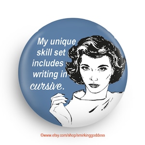 May include: A blue button with a white outline features a black and white illustration of a woman with a serious expression. The text on the button reads "My unique skill set includes writing in cursive."