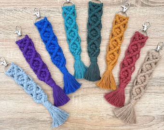 May include: A set of ten colourful macrame keychains with tassels. The keychains are made with different coloured yarn and have a variety of patterns.