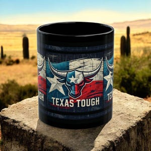 May include: Black ceramic mug with a distressed Texas flag design featuring a red bull with a white star on its forehead. The text "Texas Tough" is printed in white below the bull.