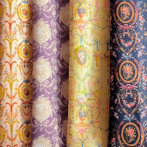 May include: Four rolls of patterned fabric in various colours. The patterns include floral and ornate designs in shades of yellow, purple, and blue. The fabric is measured in centimetres.