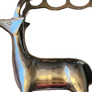 May include: A polished brass deer sculpture with a rack of antlers. The deer has a sleek, reflective surface and a detailed design. The sculpture is a decorative item, suitable for home decor.