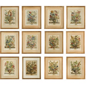 May include: Twelve framed botanical prints featuring colorful flower arrangements in vases. Each print is set against a cream background and has a gold frame.