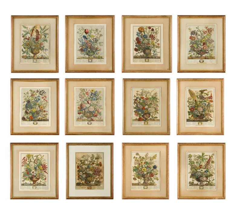 May include: Twelve framed botanical prints featuring colorful flower arrangements in vases. Each print is set against a cream background and has a gold frame.