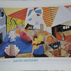 May include: A colorful abstract painting by David Hockney titled "A Room for Composing (The Studio)". The painting depicts a room with furniture, a piano, and a window. The colors are bright and bold, and the lines are sharp and angular.