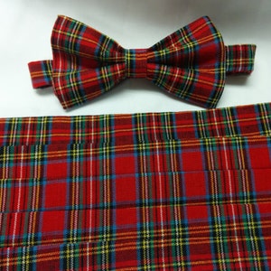 May include: Red, green, and blue plaid bow tie and matching cummerbund. The bow tie is tied and the cummerbund is folded.