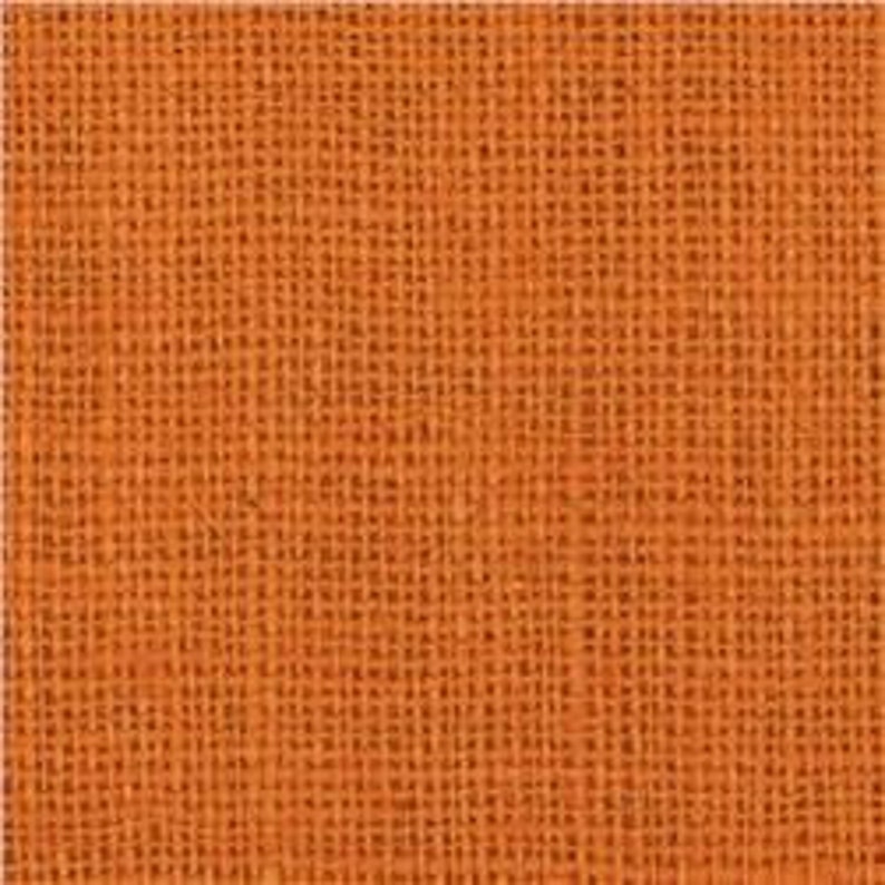 Puede incluir: Primer plano de un trozo de tela de arpillera naranja. La tela tiene una textura rugosa y un patr&oacute;n tejido.