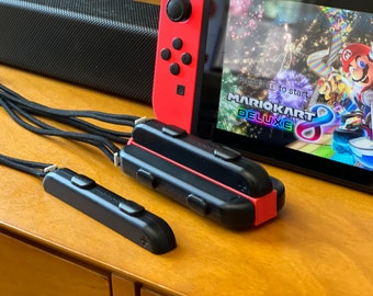 Correa de muñeca para Joy-Con de Nintendo Switch, compatible con hasta cuatro mandos, accesorio compacto para juegos, organizador de juegos, perfecto para viajes.
