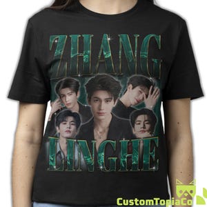 May include: A black short-sleeved t-shirt featuring a graphic print of the actor Zhang Linghe. The design includes five photographic portraits of the individual arranged in a collage, with the name ZHANG LINGHE in large, metallic green lettering.
