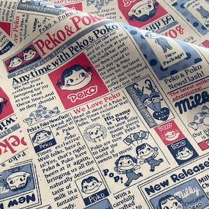 4885 - Milky Peko Poko Peko-Chan Newspaper Cotton Fabric - 62 Inch (Width) x 1/2 Yard (Length)