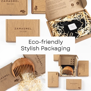 May include: Eco-friendly packaging for a wooden comb. The comb is made of natural wood and comes in a brown cardboard box with the brand name "Zamasmel Wood" printed on it. The box is filled with shredded paper for protection.