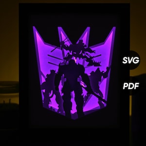 May include: A black framed, illuminated art piece featuring a purple and black design. The design includes a purple emblem with silhouetted figures and the text "SVG" and "PDF". The artwork is lit from behind, creating a glowing effect.