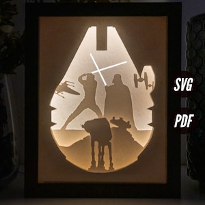 Könnte beinhalten: Ein gerahmtes, beleuchtetes Silhouette-Kunstwerk mit Star Wars-Charakteren, darunter Darth Vader, Luke Skywalker und ein AT-AT-Walker. Die Figuren sind vor einem weißen Hintergrund silhouettiert, und das Licht scheint durch die Ausschnitte und erzeugt einen dramatischen Effekt.