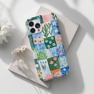Op de afbeelding: Een telefoonhoesje met een kleurrijk patchwork-ontwerp met bloemen, bladeren en geometrische vormen. Het hoesje is gemaakt van duurzaam materiaal en heeft een transparante achterkant om de telefoon te laten zien.