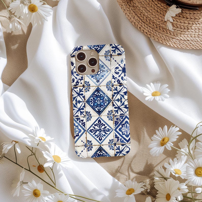 May include: A blue and white phone case with a geometric tile pattern. The case is designed for an iPhone with a camera lens cutout.