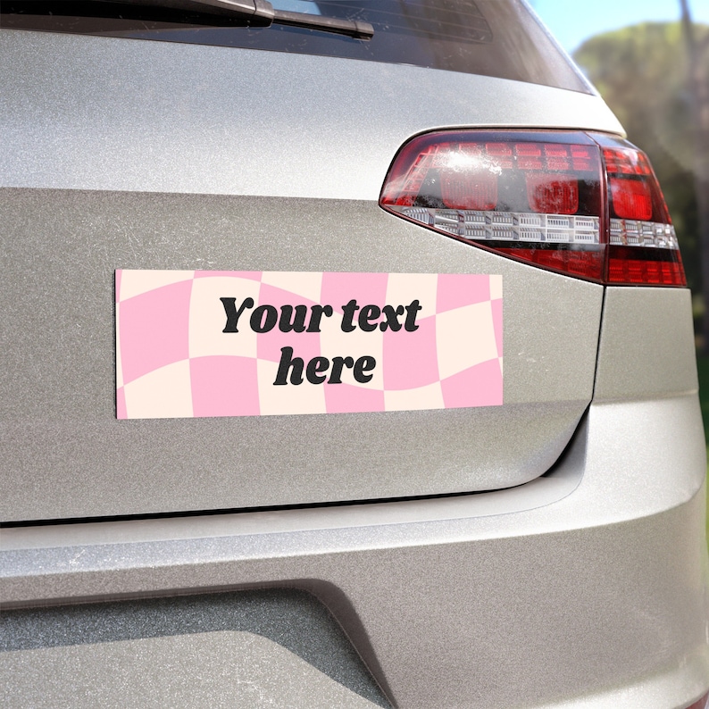 May include: A pink and white checkered car bumper sticker with the text "Your text here".