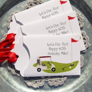 Golf birthday party favors, personalized for the guest of honor, printed on white card stock adorned with a red ribbon.  Let's Par Tee golf favors, slide a lotto ticket in for a fun birthday favor.