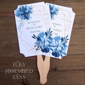 Personalized blue wedding favor fans, guests will love these on a warm day.  The artistic navy foliage creates a stylish frame, impressive.
