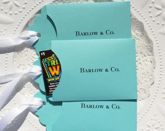 Wedding lotto favor envelopes personalized for the bride and groom.  Favors for Tiffany printed on aqua cardstock with white ribbon attached