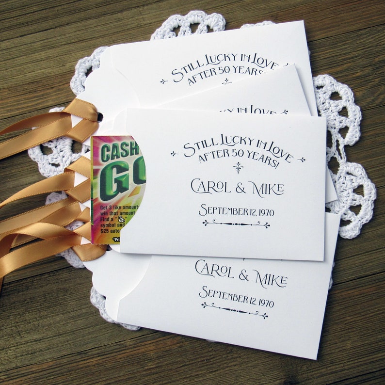Our 50th wedding anniversary favors are personalized for the happy couple.  Printed on white cardstock with gold ribbon attached these will be a fun favor to give to guests.  Slide a lotto ticket in the open end and see who wins.